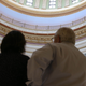 The names of large corporations, including oil and gas companies of Oklahoma’s past and present like Halliburton, are etched into the stone of the rotunda of the Oklahoma State Capitol building. Retired lobbyist Mickey Thompson shows it to Fusion’s Natasha Del Toro. Credit: Fusion